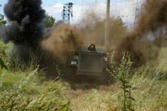 A Russian military robotic vehicle detonates a land mine on a mine clearing mission along the high voltage line in Mariupol.