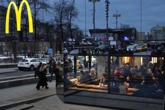 Muscovites eating in a McDonald’s on Sunday March 13, after the fast food giant said it would shutter its stores in Russia. 