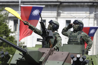 Taiwanese soldiers salute during National Day celebrations in front of the Presidential Office Building in Taipei in October. 