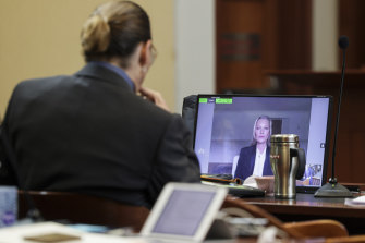 Johnny Depp watches as his ex-girlfriend Kate Moss testifies via video link.