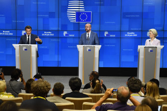 From left, French President Emmanuel Macron, European Council President Charles Michel and European Commission President Ursula von der Leyen make the announcement.