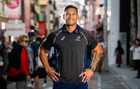Star attraction: Folau poses for the cameras at a Wallabies fan event in the Harajuku district of downtown Tokyo.