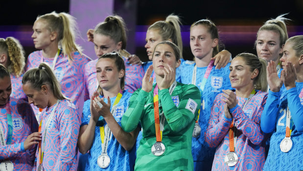 England players pose with their second place medals at the end of the Women’s World Cup soccer final on Sunday.