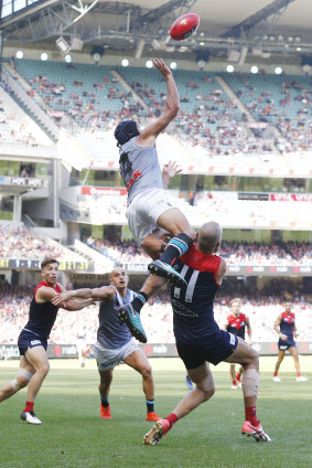 Paddy Ryder flies over Max Gawn.