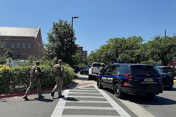 Police officers outside the university campus after the shooting.