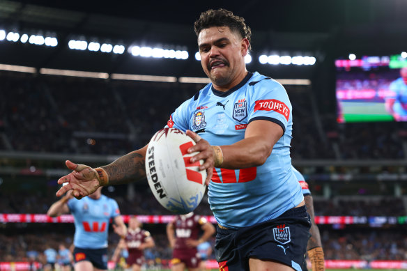 Latrell Mitchell celebrates scoring for the Blues.