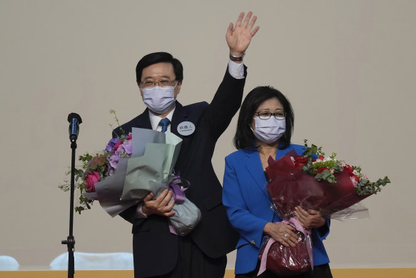 John Lee, former No. 2 official in Hong Kong and the only candidate for the city’s top job, celebrates with his wife after declaring his victory in the chief executive election of Hong Kong on Sunday.