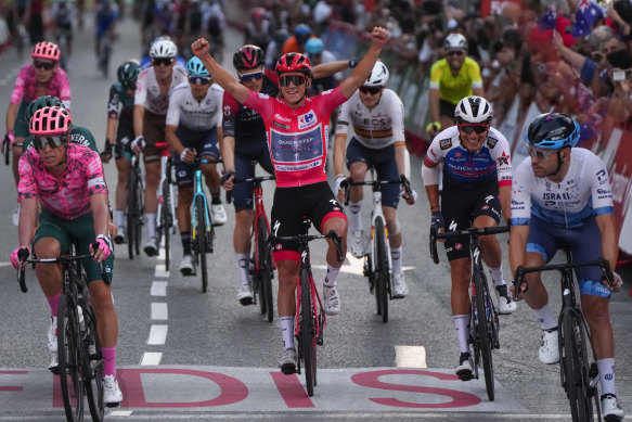 Remco Evenepoel, riding for Quick-Step Alpha Vinyl, crosses the line on the final stage to win the Vuelta.