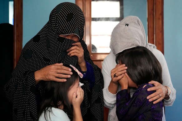The family of a 19-year-old girl who was the victim of a suicide bomber mourns, in Kabul on Friday.