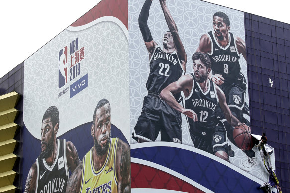 A billboard advertising an NBA preseason game between the Los Angeles Lakers and Brooklyn Nets in Shanghai.