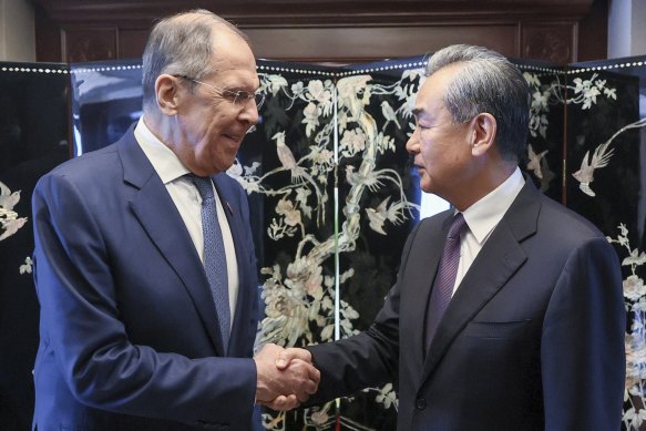 In this photo released by Russian Foreign Ministry Press Service, Russian Foreign Minister Sergey Lavrov, left, and Chinese Communist Party’s foreign policy chief Wang Yi shake hands.