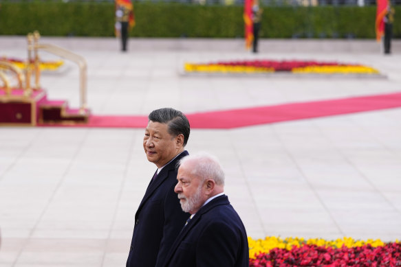 Brazilian President Luiz Inacio Lula da Silva, right, and Chinese President Xi Jinping walk during a welcome ceremony outside the Great Hall of the People in Beijing.