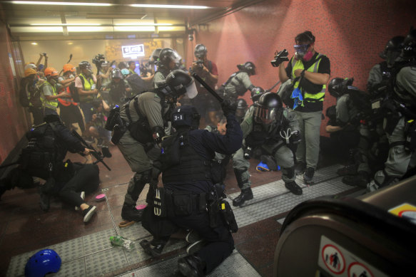 Policemen charge and arrest protesters inside the Tai Koo MTR station during the anti-extradition bill protest in Hong Kong on Sunday night.