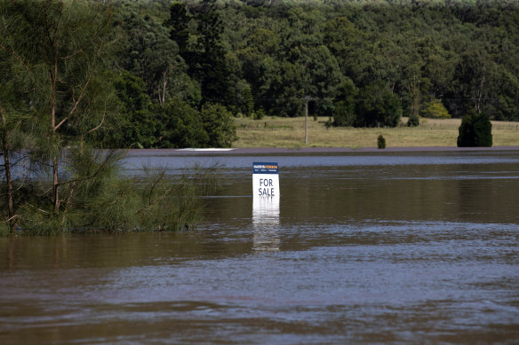 A ‘For Sale’ sign for a flooded property on the Macdonald River, near Wisemans Ferry, NSW.