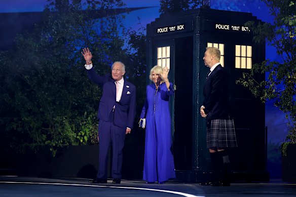 King Charles III and Queen Camilla wave after walking out of the Tardis.