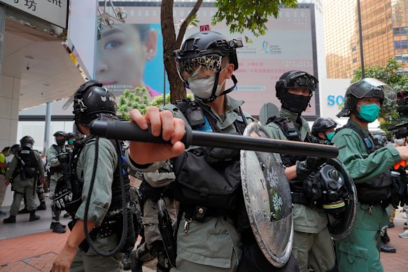 Riot police form a line as they plan to clear away people gathered in the Central district in Hong Kong last week.