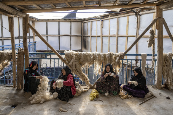 Women weave wool for making carpets at a traditional carpet factory in Kabul, Afghanistan, last month. Many have lost the freedom to work and study since the Taliban’s return to power.