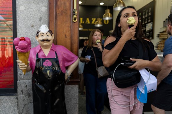 People buy ice-creams at Puerta del Sol square in Madrid, Spain, during the weekend heatwave.
