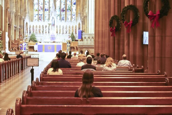 People attend mass at St Mary's Cathederal in Sydney on Wednesday afternoon following the latest COVID-19 social distancing rules.