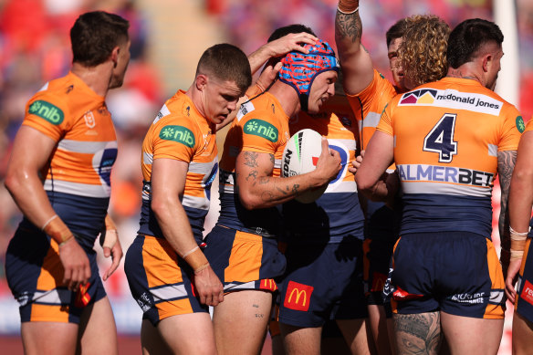 Knights players celebrate a try with star fullback Kalyn Ponga.