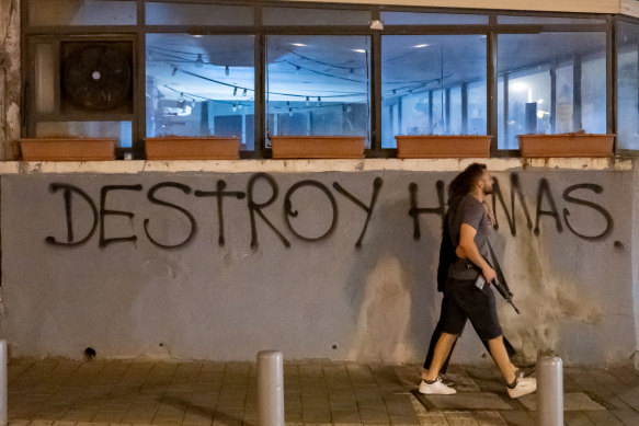 People walk down the street in Tel Aviv, Israel.