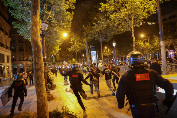 Police officers and rioters on the Champs-Elysees in Paris on Saturday.