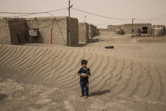 A young resident of al-Najim, Iraq, a small agricultural village north of Nasiriyah that has been covered by shifting sand dunes. 