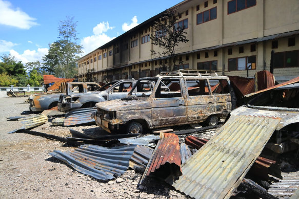 Burnt out vehicles stretch across a car park since Monday's violent protest in Wamena, Papua province, Indonesia.