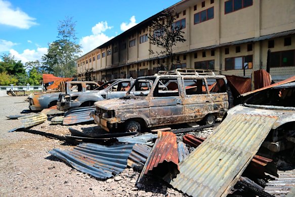 Burnt out vehicles stretch across a car park since Monday's violent protest in Wamena, Papua province, Indonesia.