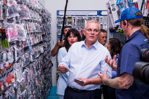 Prime Minister Scott Morrison campaigns in a camping store in West Gosford on Saturday 
