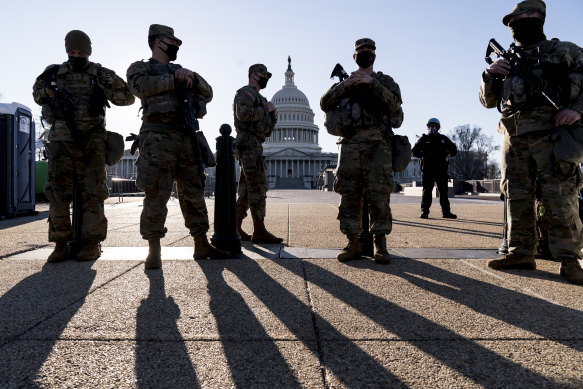 Members of the Michigan National Guard and the US Capitol Police keep watch as heightened security remains in effect around the Capitol. 