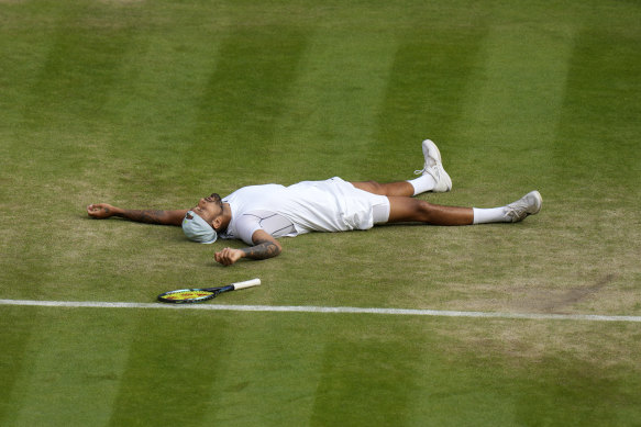 Australia’s Nick Kyrgios lies on the ground after defeating Chile’s Cristian Garin.