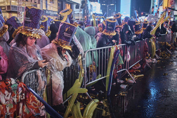 Revellers gather under the rain as they wait for the countdown during the New Year’s Eve celebrations in Times Square, late Saturday, December 31.