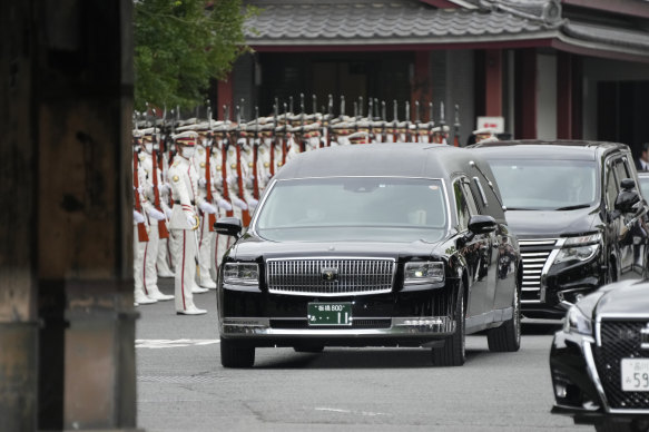 The vehicle carrying the body of former Japanese Prime Minister Shinzo Abe leaves Zojoji temple after his funeral in Tokyo on Tuesday.