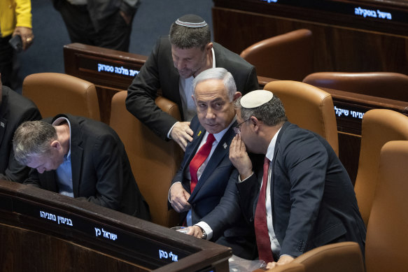Prime Minister Benjamin Netanyahu, centre, surrounded by ministers from the government attends a session of the Knesset, Israel’s parliament, in Jerusalem, on Monday.