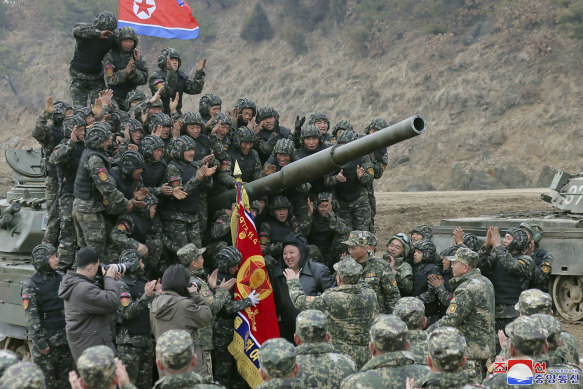 North Korean leader Kim Jong-un, centre, meets soldiers who took part in training in North Korea.