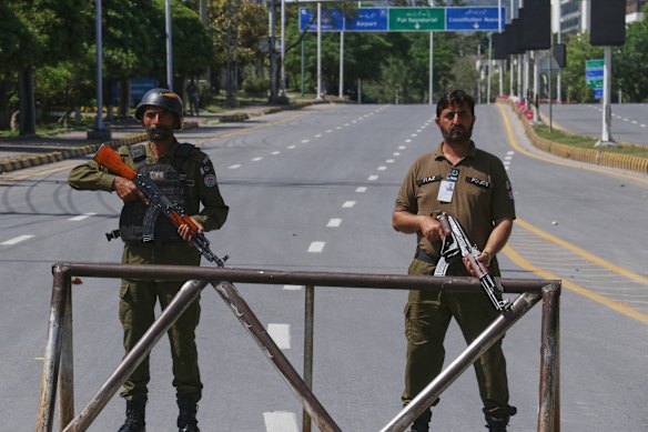 Police officers stand guard at a checkpoint on a road leading to Serena Hotel ahead of a second round of peace talks.