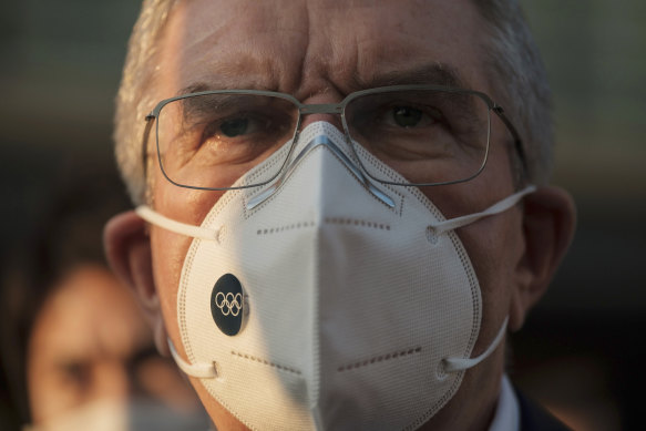 IOC President Thomas Bach wears a mask in Tokyo late last year.