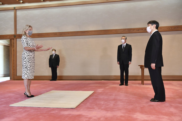 Socially distant but politically close: US first lady Jill Biden meets Japanese Emperor Naruhito, right, at the Imperial Palace in Tokyo before the Olympics opening ceremony on Friday.