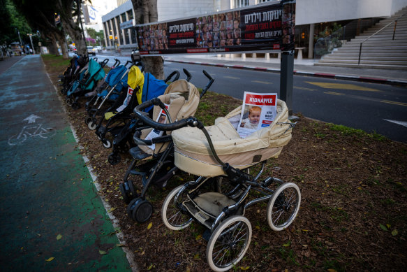 An installation of strollers with the faces of children kidnapped  by Hamas, in Tel Aviv, on Saturday.