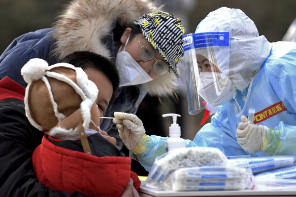 A child is tested for COVID-19 in a residential area in Shijiazhuang, Hebei province, China, on Sunday.