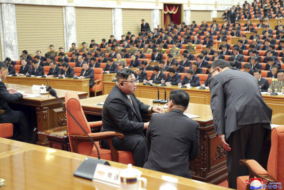 North Korean leader Kim Jong-un, third right, speaks with people involved during a meeting of the ruling Workers’ Party. Independent journalists were not given access to cover the event.
