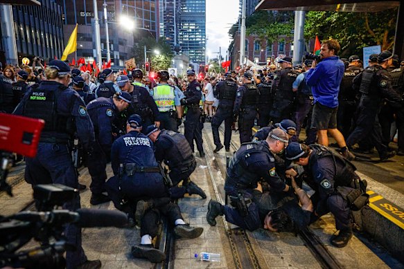 Police detain protesters during a protest against the visit of Israeli President Isaac Herzog on February 9 in Sydney.