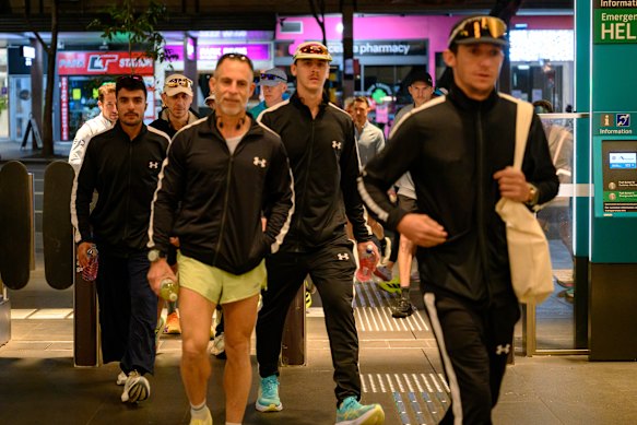 Marathon runners head to the metro line. 