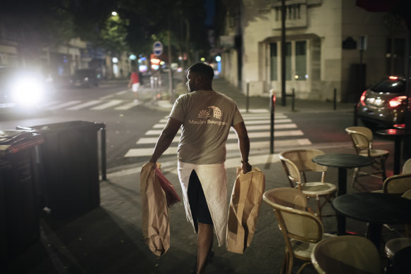 Home delivery: Tharshan Selvarajah carrying paper bags with his baguettes made for élysée Palace.