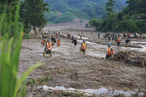 Rescue workers search for the missing after floods in Vietnam’s Lao Cai province on Sunday.