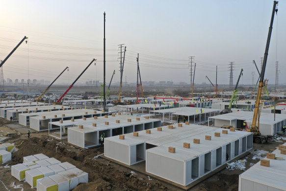 Workers build a large centralised quarantine facility capable of holding several thousand people in Shijiazhuang in northern China's Hebei Province. China on Saturday finished building a 1500-room hospital for COVID-19 patients in Nangong, south of Beijing in Hebei Province, to fight a surge in infections.