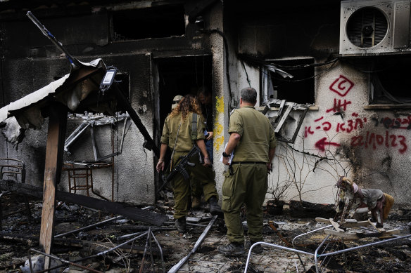 Israeli soldiers inspect houses destroyed by Hamas militants in Kibbutz Nir Oz, southern Israel, last week.