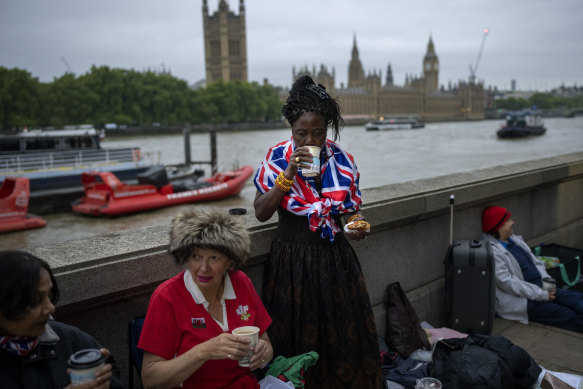 Vanessa, Anne and Grace, from left to right, have breakfast as they wait opposite the Palace of Westminster.