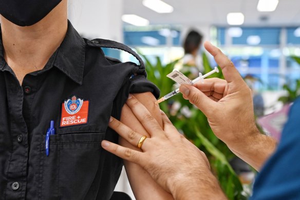 An emergency worker receives a COVID-19 vaccine at the new mass vaccination hub at Sydney’s Olympic Park.
